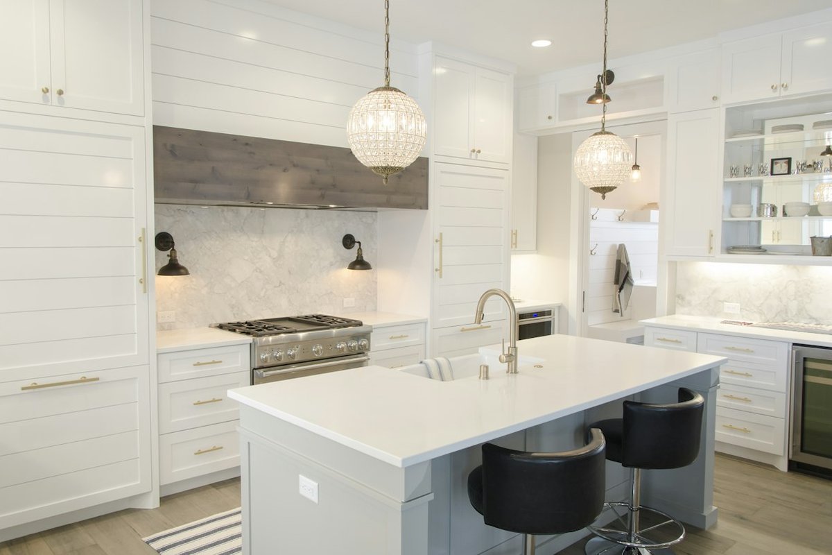 Before remodel: Cramped u-shaped kitchen with dark soffits and outdated cabinets in La Mesa.