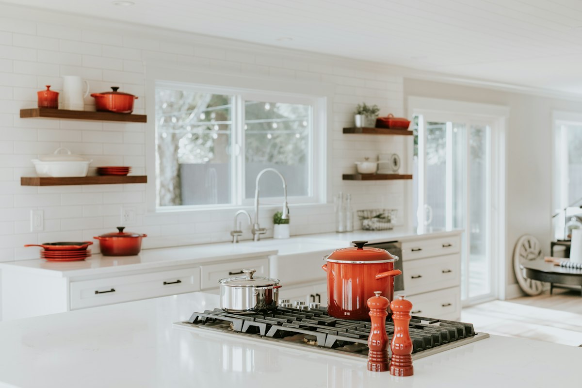 After remodel: Sunlit open-concept kitchen with floating shelves and seamless dining connection in La Mesa.
