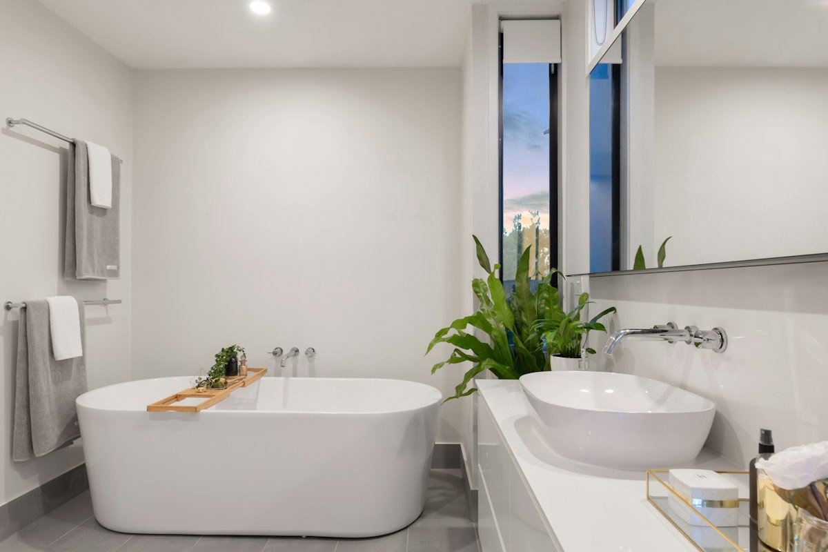 After remodel: Contemporary walk-in standup shower with low-profile curb and frameless glass in El Cajon.